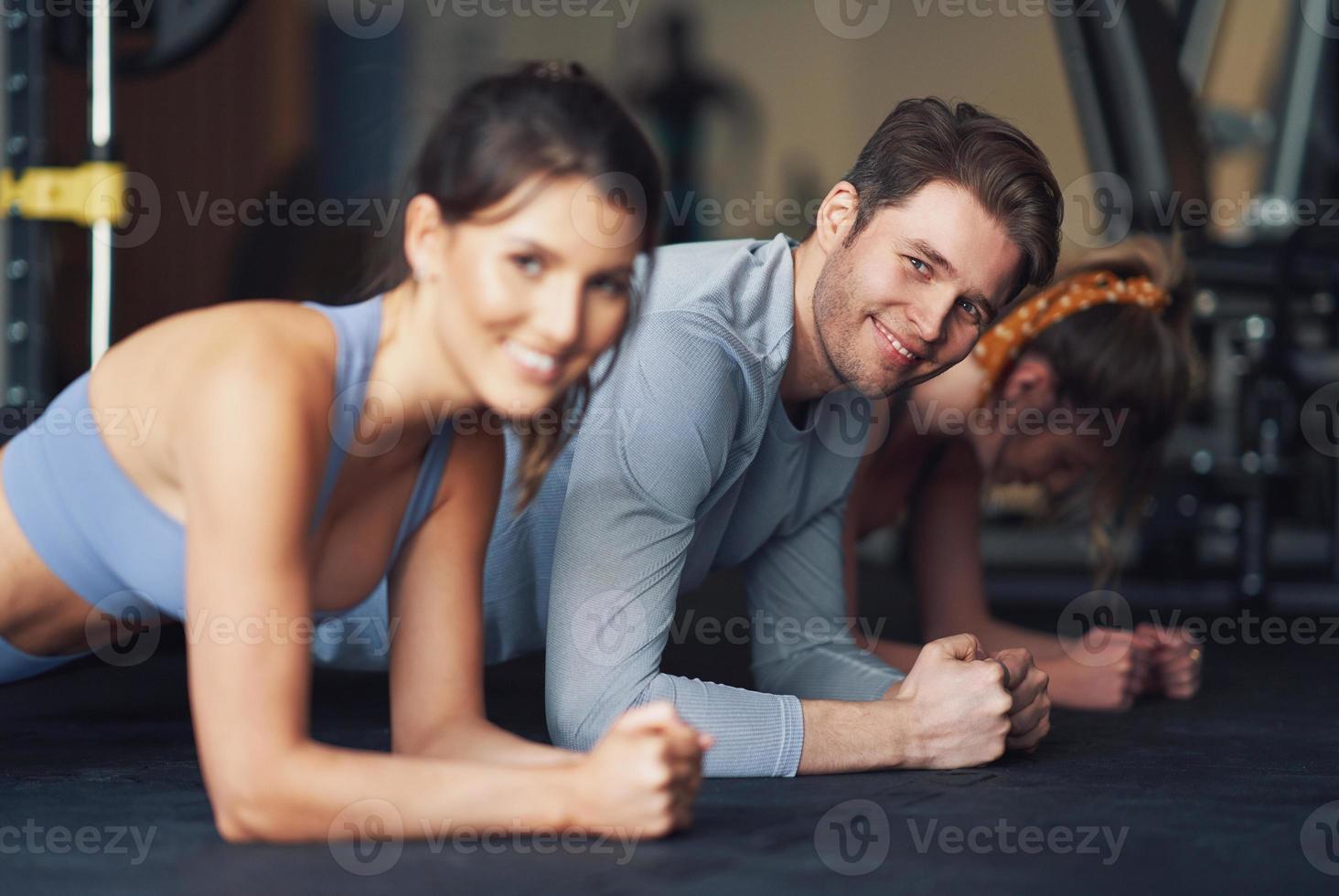 Group of people working out in a gym photo