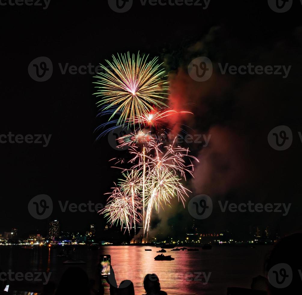 Abstract colored firework background light up the sky with dazzling display photo