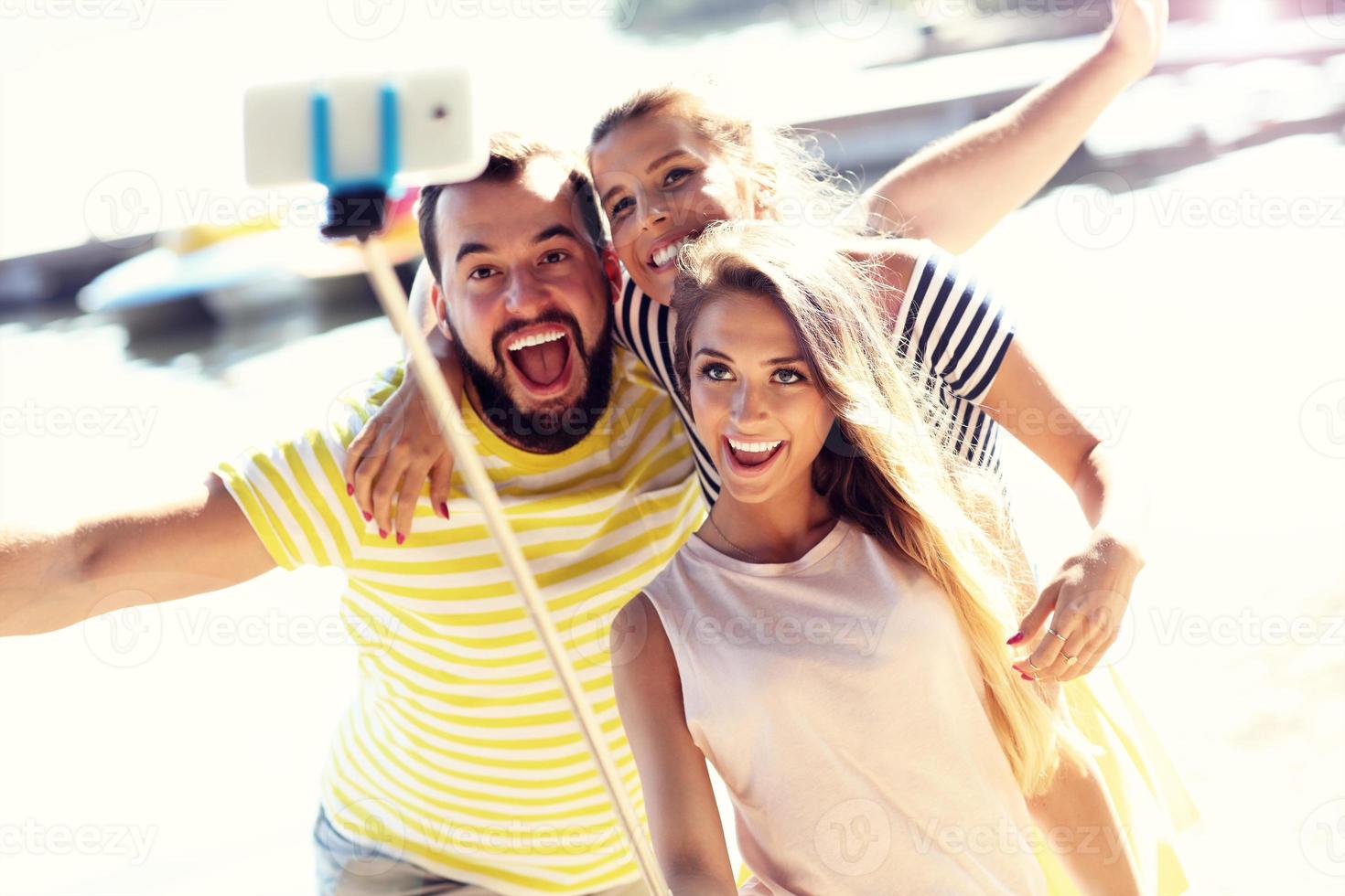 Group of friends having fun outdoors in summer photo