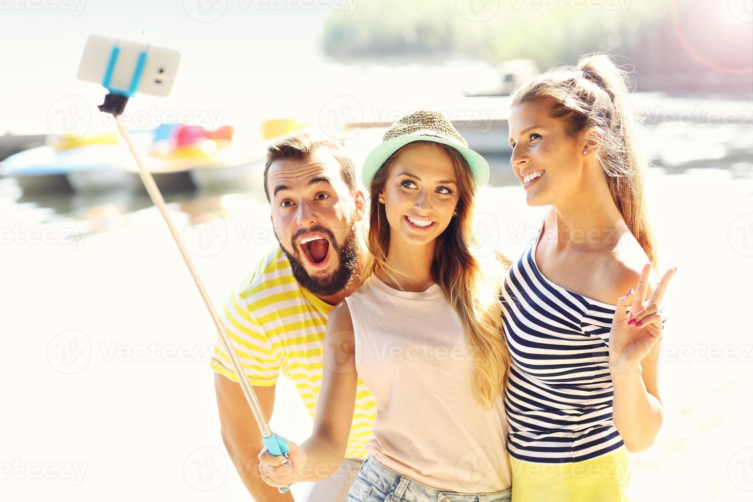 Group of friends having fun outdoors in summer photo