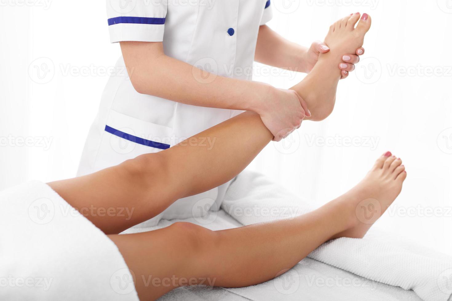 A picture of woman having leg therapy photo