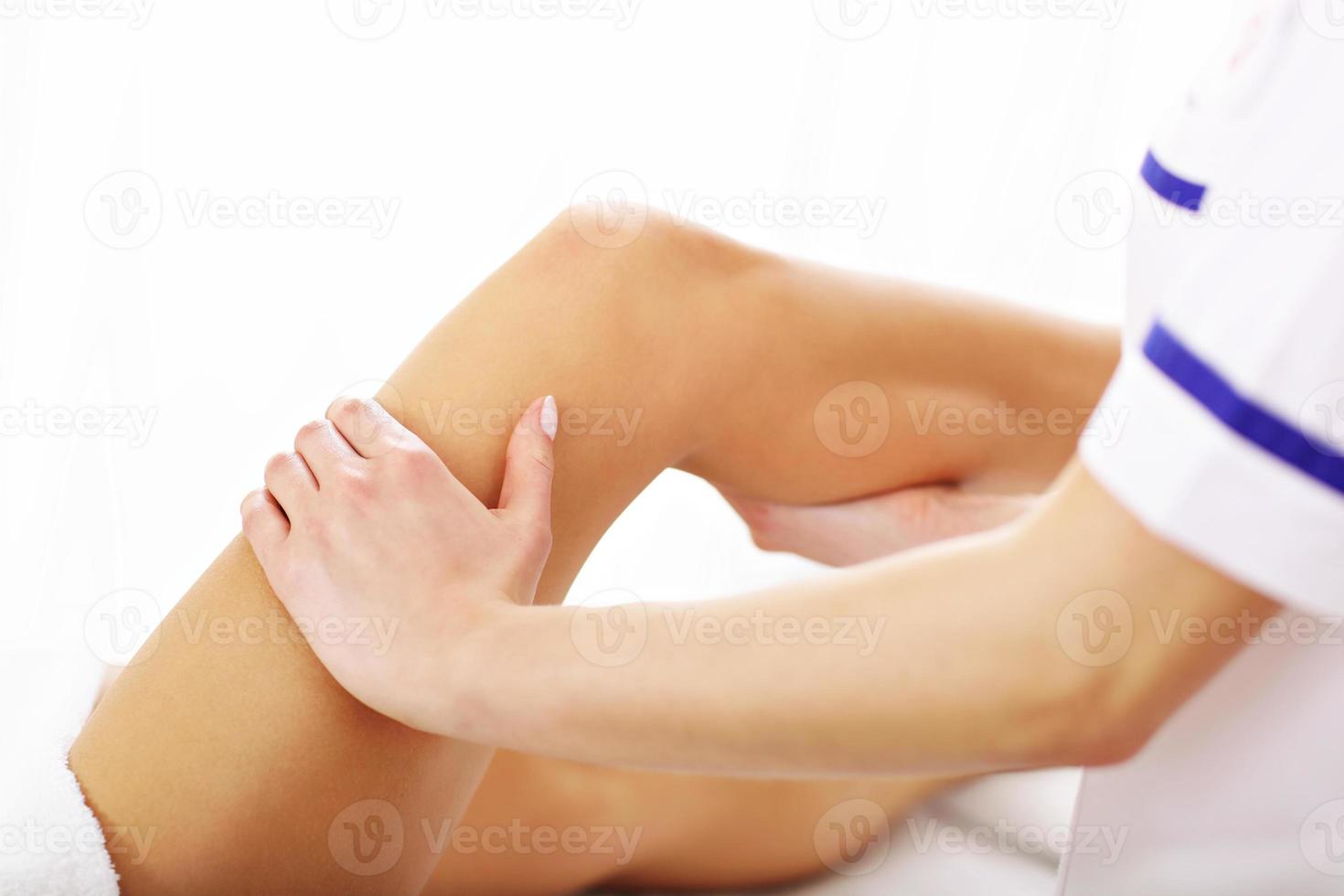 A picture of woman having leg therapy photo