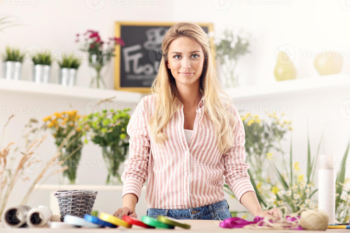 Female florist working in flower shop photo