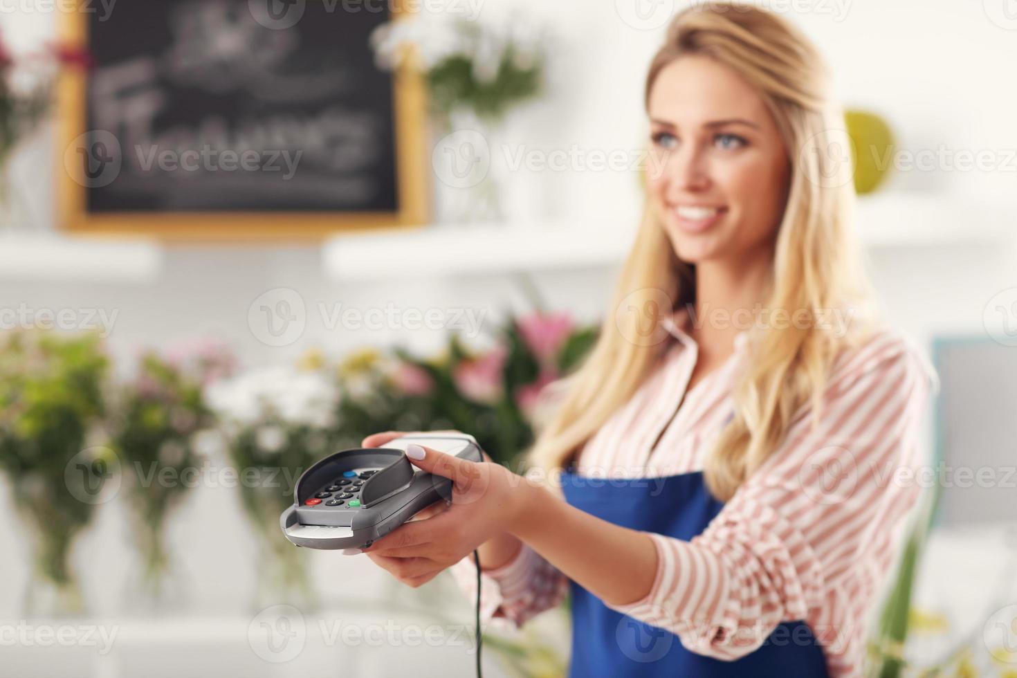 Female florist working in flower shop photo