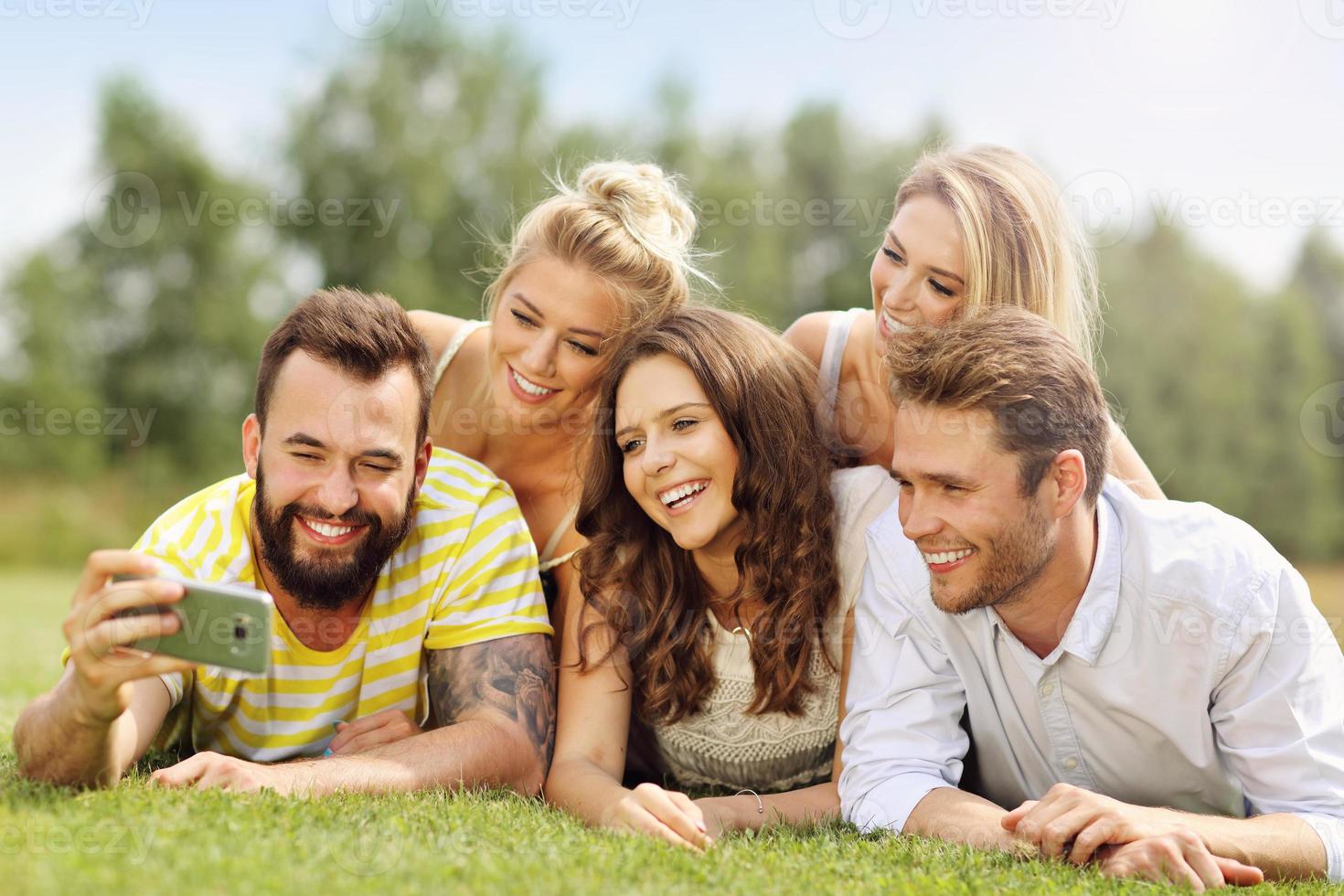Friends group having fun together on grass photo