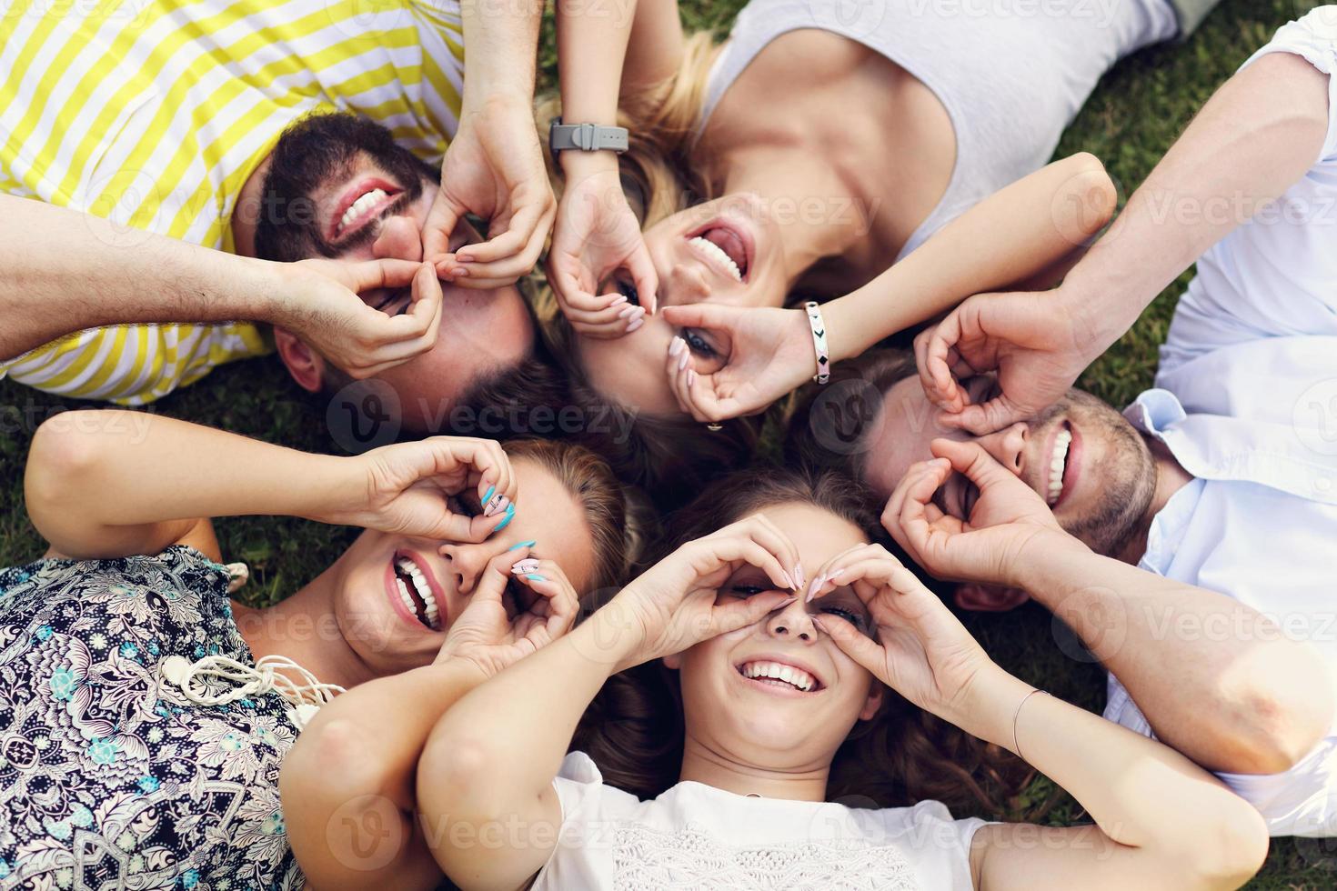 Friends group having fun together on grass photo