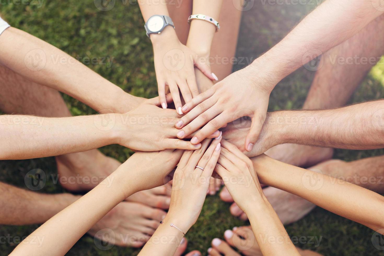 Group of friends bonding hands together photo