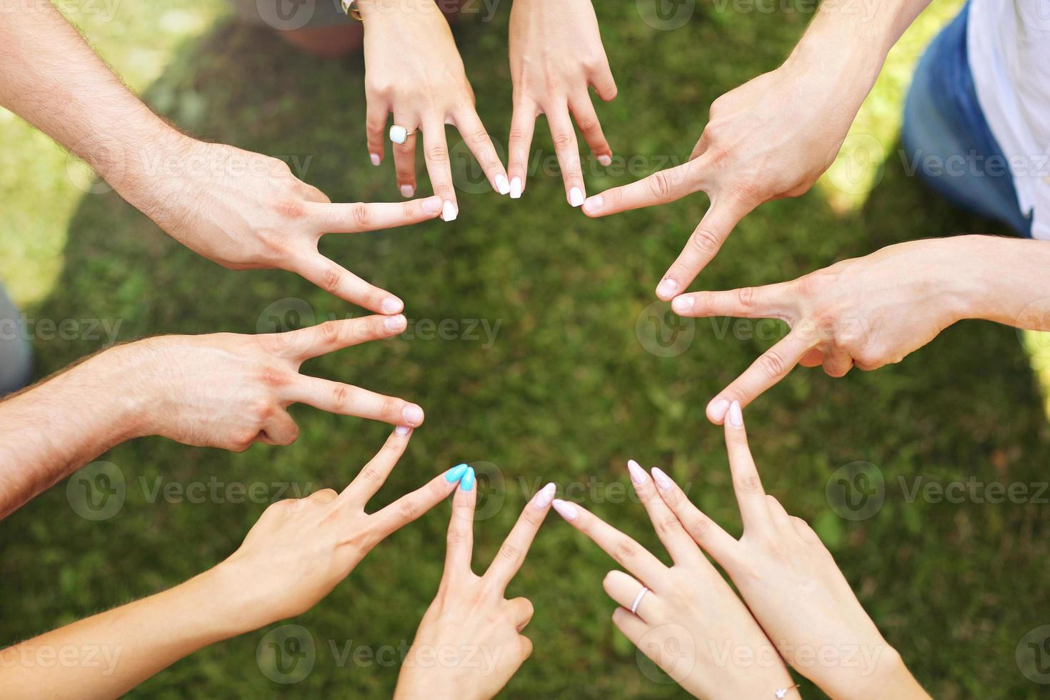 Group of friends bonding hands together photo