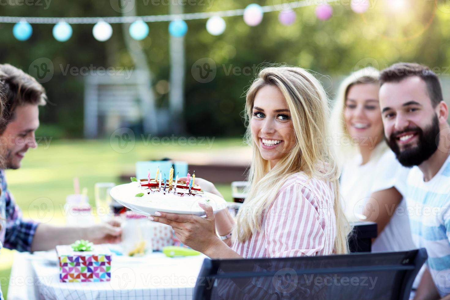 Group of friends having fun at birthday party photo