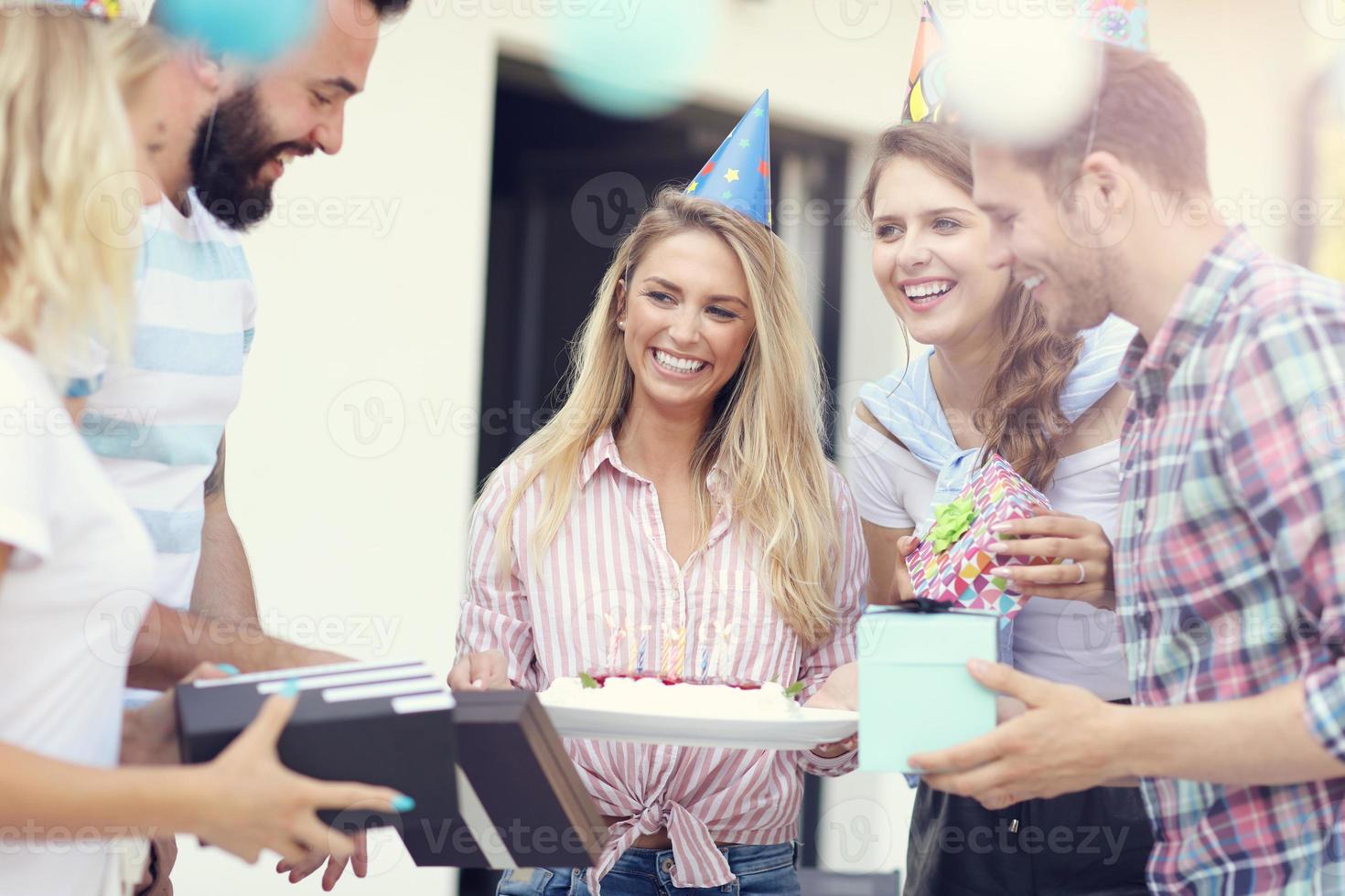 Group of friends having fun at birthday party photo