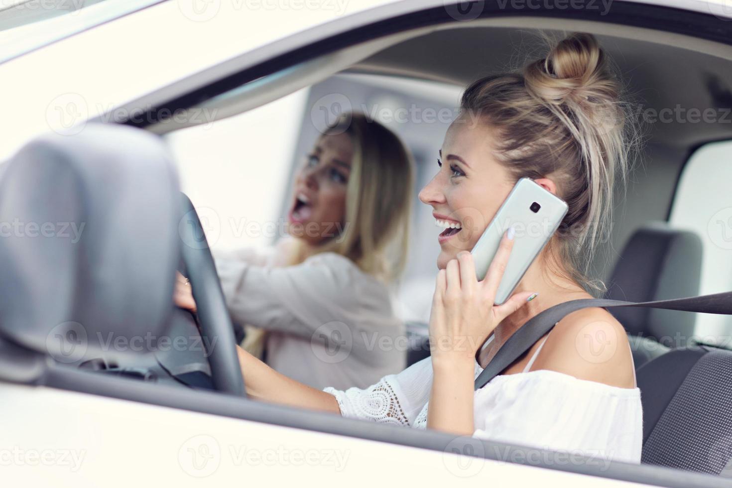 Woman talking on phone while driving photo