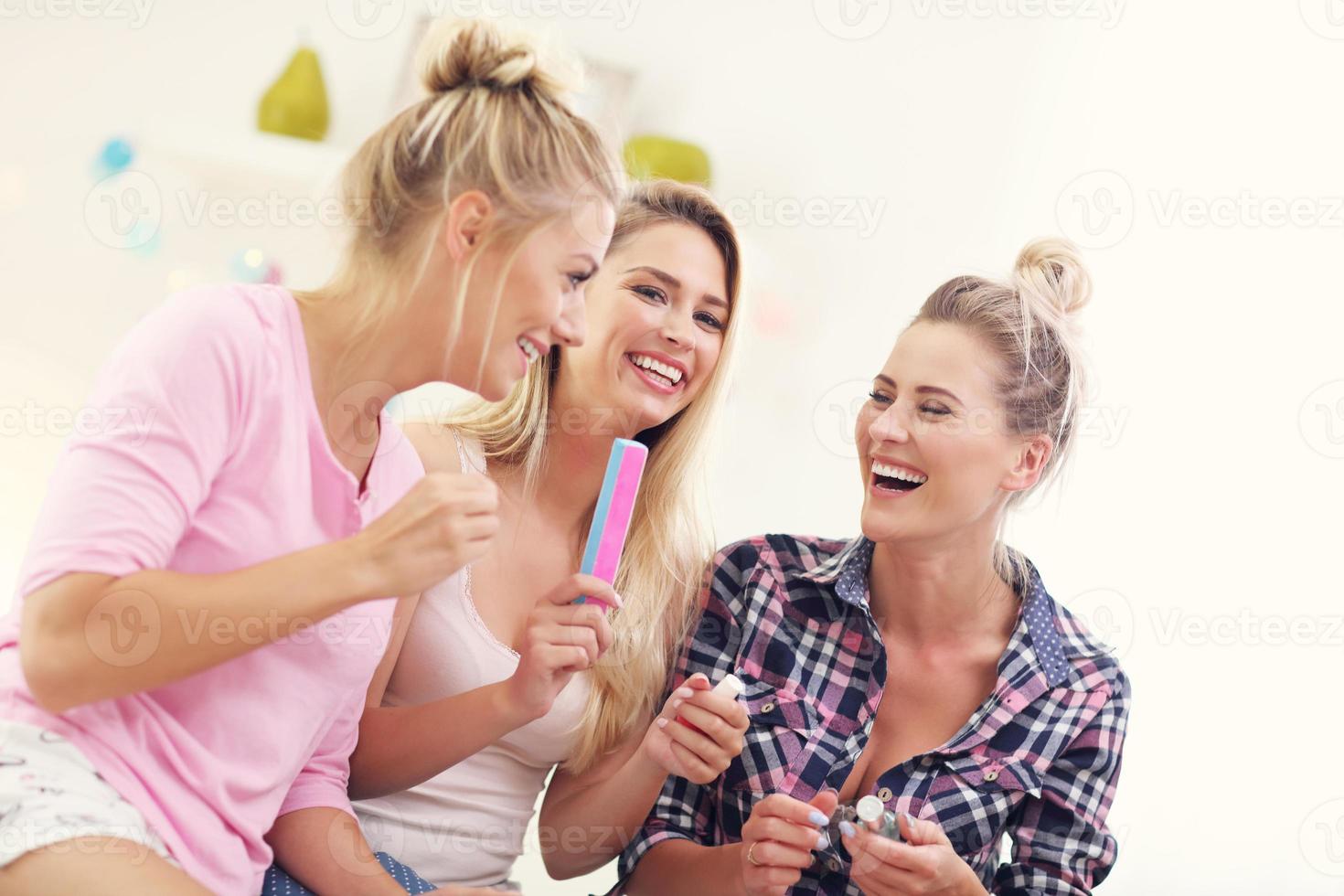 Three beautiful young women chilling at home photo