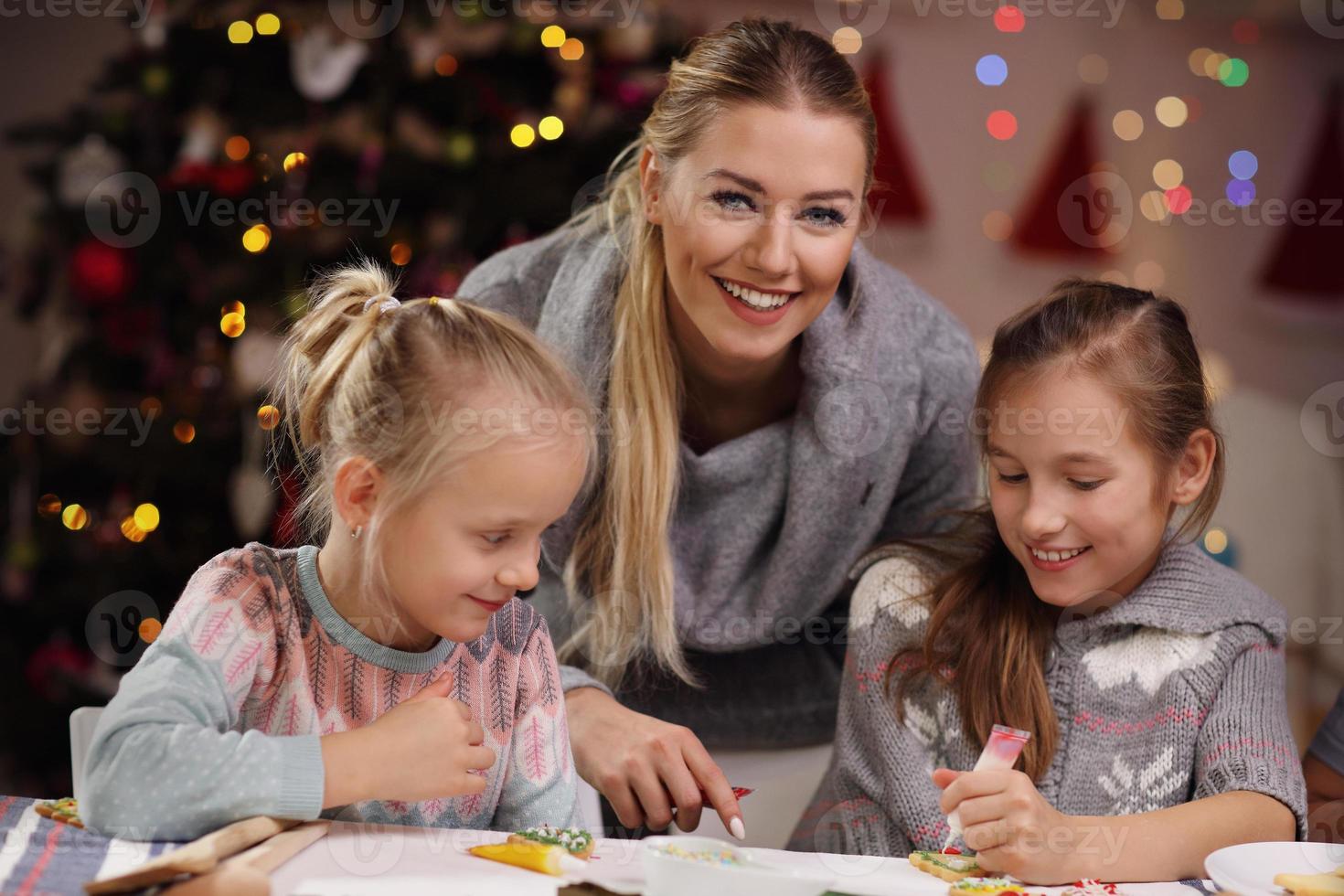 Joyful family preparing Christmas biscuits photo