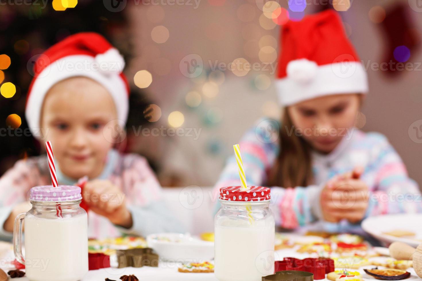 Happy little sisters preparing Christmas biscuits photo