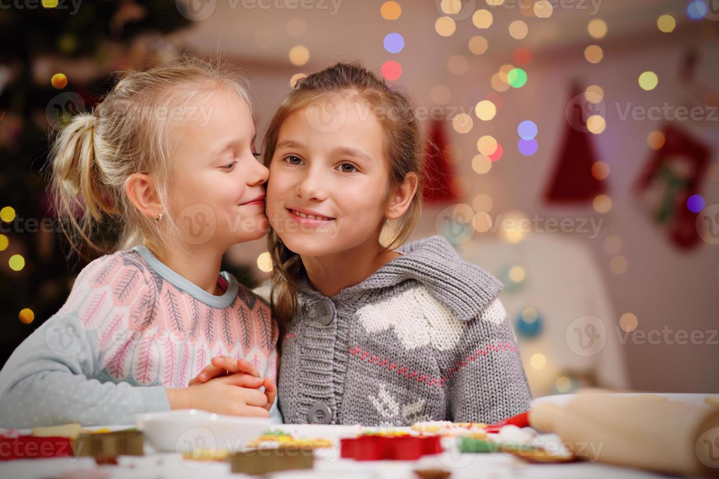 Happy little sisters preparing Christmas biscuits photo