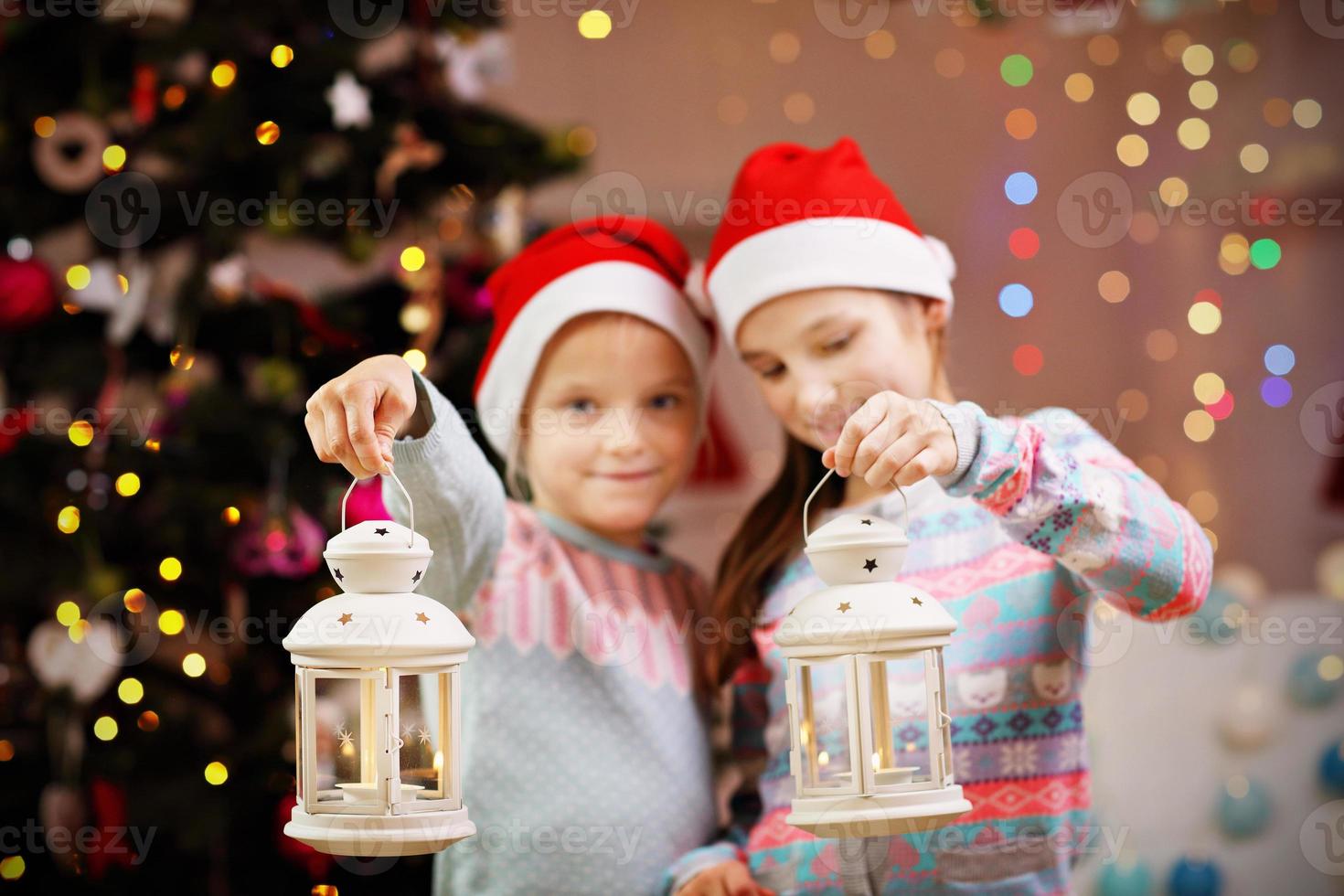 Happy children posing with Christmas lanterns photo