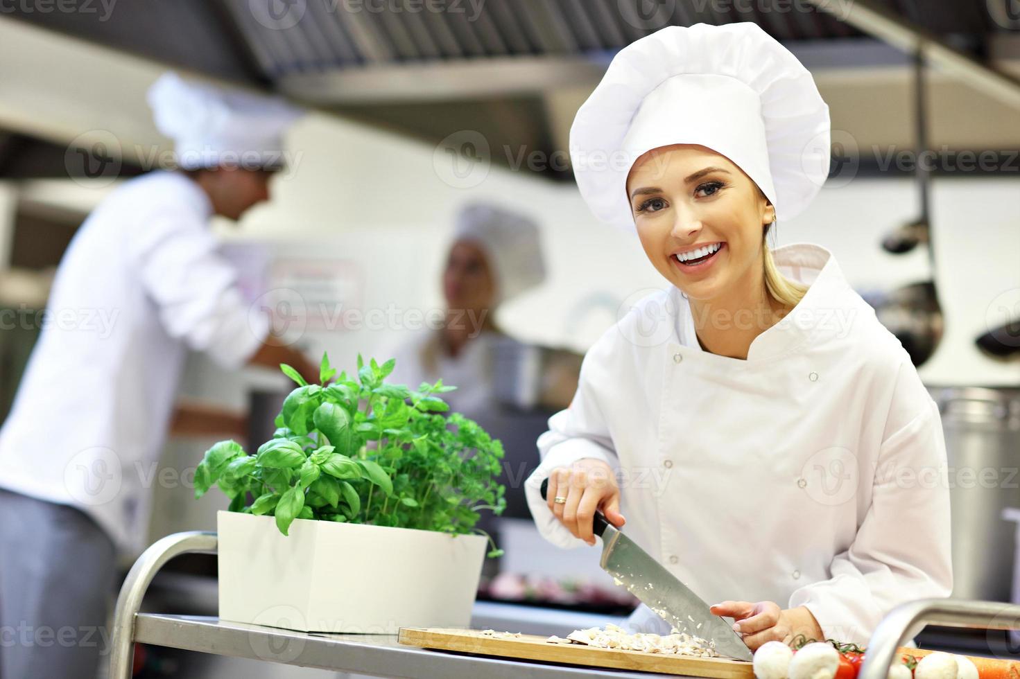 Busy chefs at work in the restaurant kitchen photo