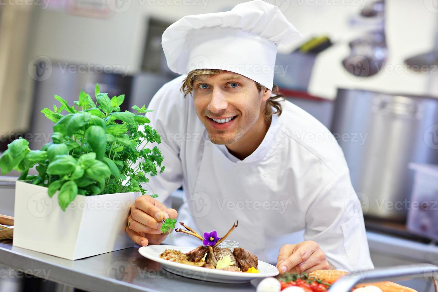 Busy chef at work in the restaurant kitchen photo