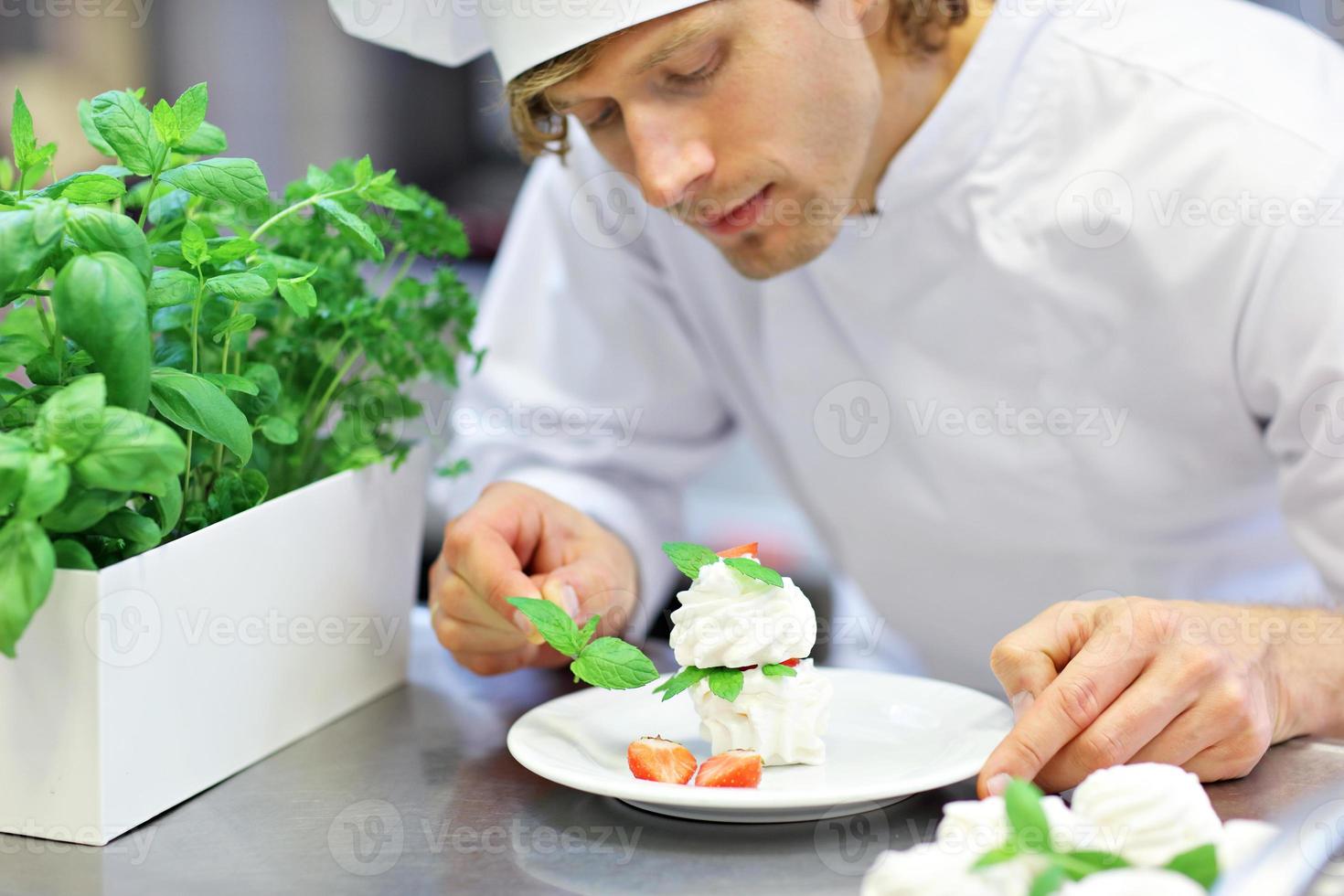 Busy chef at work in the restaurant kitchen photo