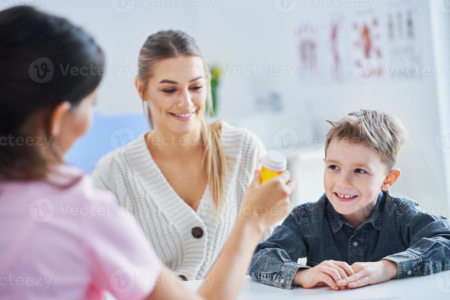 Little boy having medical examination by pediatrician photo