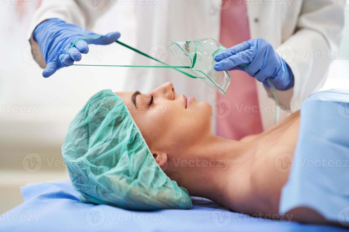 Nurse gives respiratory therapy to a patient recovering in the hospital photo