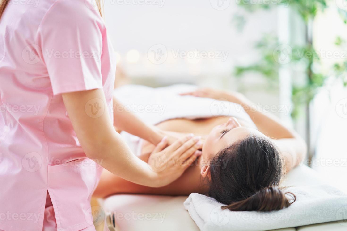 Adult woman during relaxing massage in spa photo