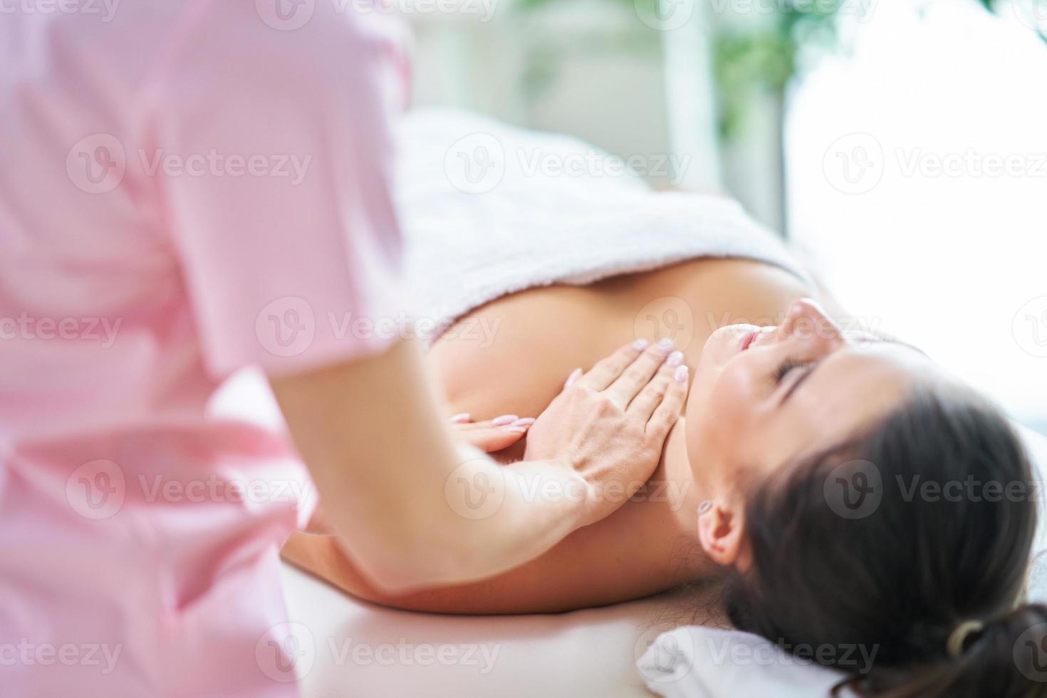 Adult woman during relaxing massage in spa photo