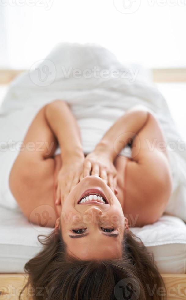 Sensual adult woman in bedroom in the morning photo