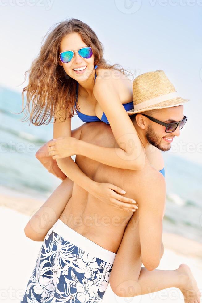 Young couple having fun at the beach photo