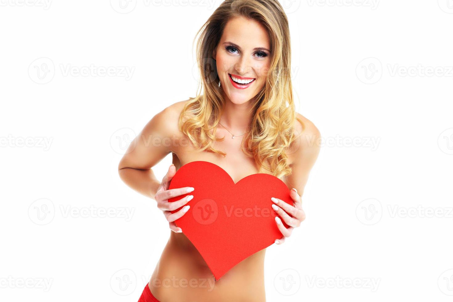 Sexy Valentine woman holding a heart photo