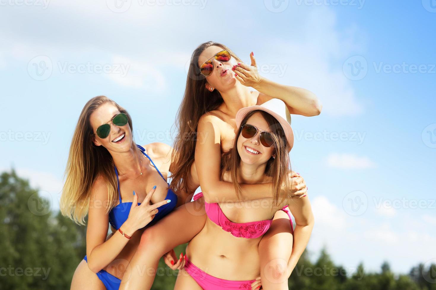 Group of women in bikin having fun outdoors photo