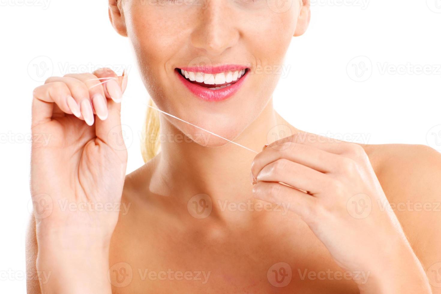 Woman using dental floss photo