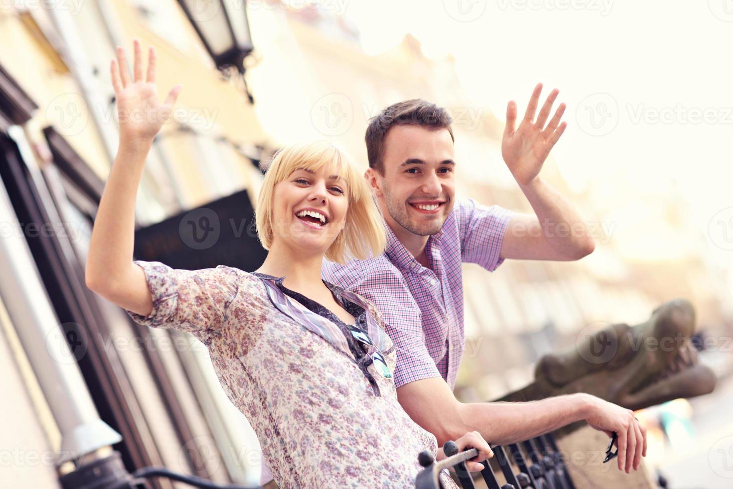 Happy tourists waving to the camera photo