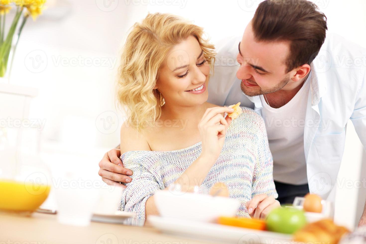 Young couple eating breakfast photo