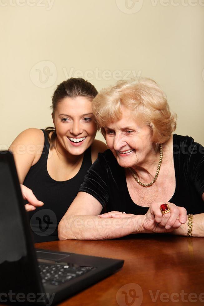 Grandma and granddaughter with a laptop photo