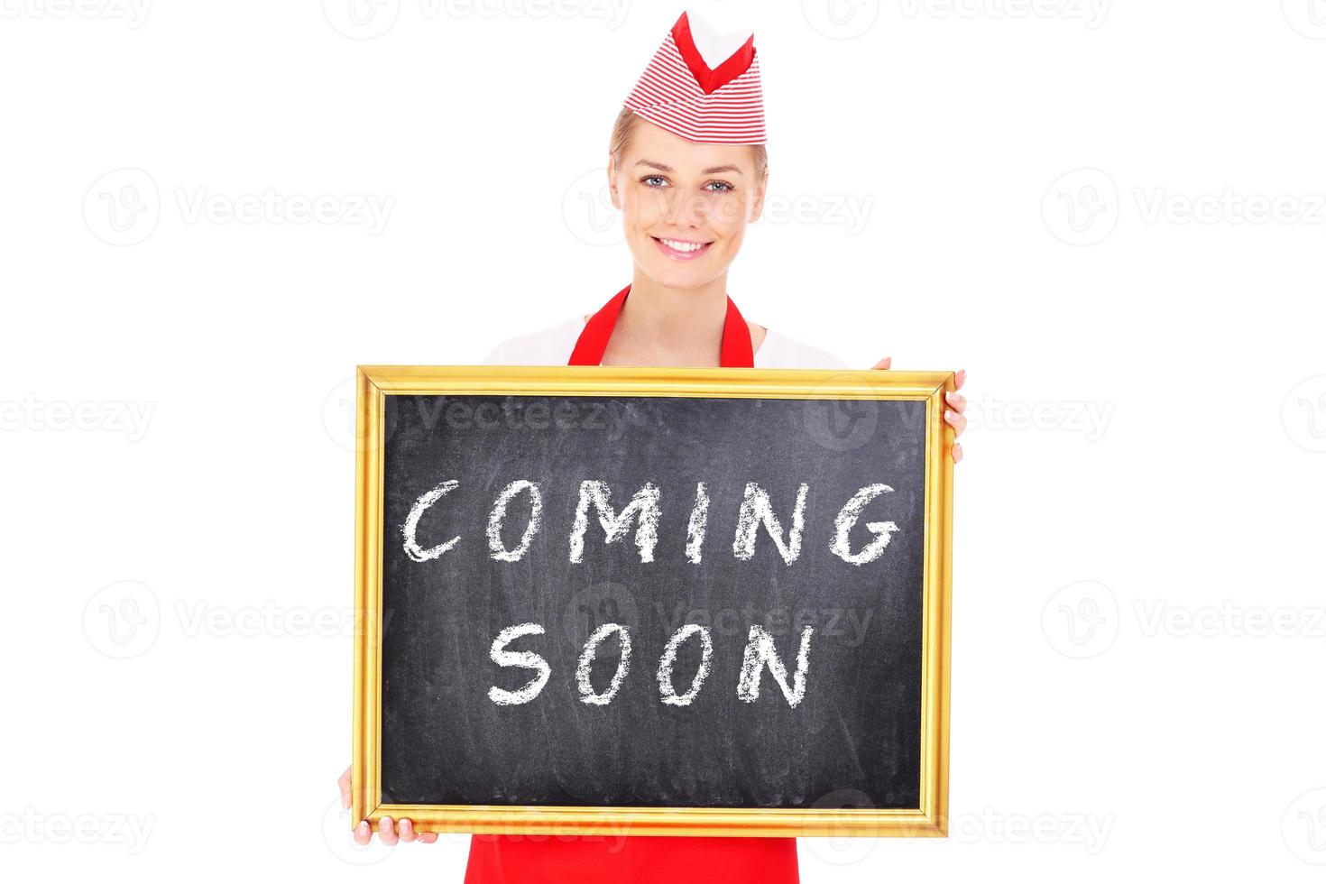 Woman with a coming soon board photo