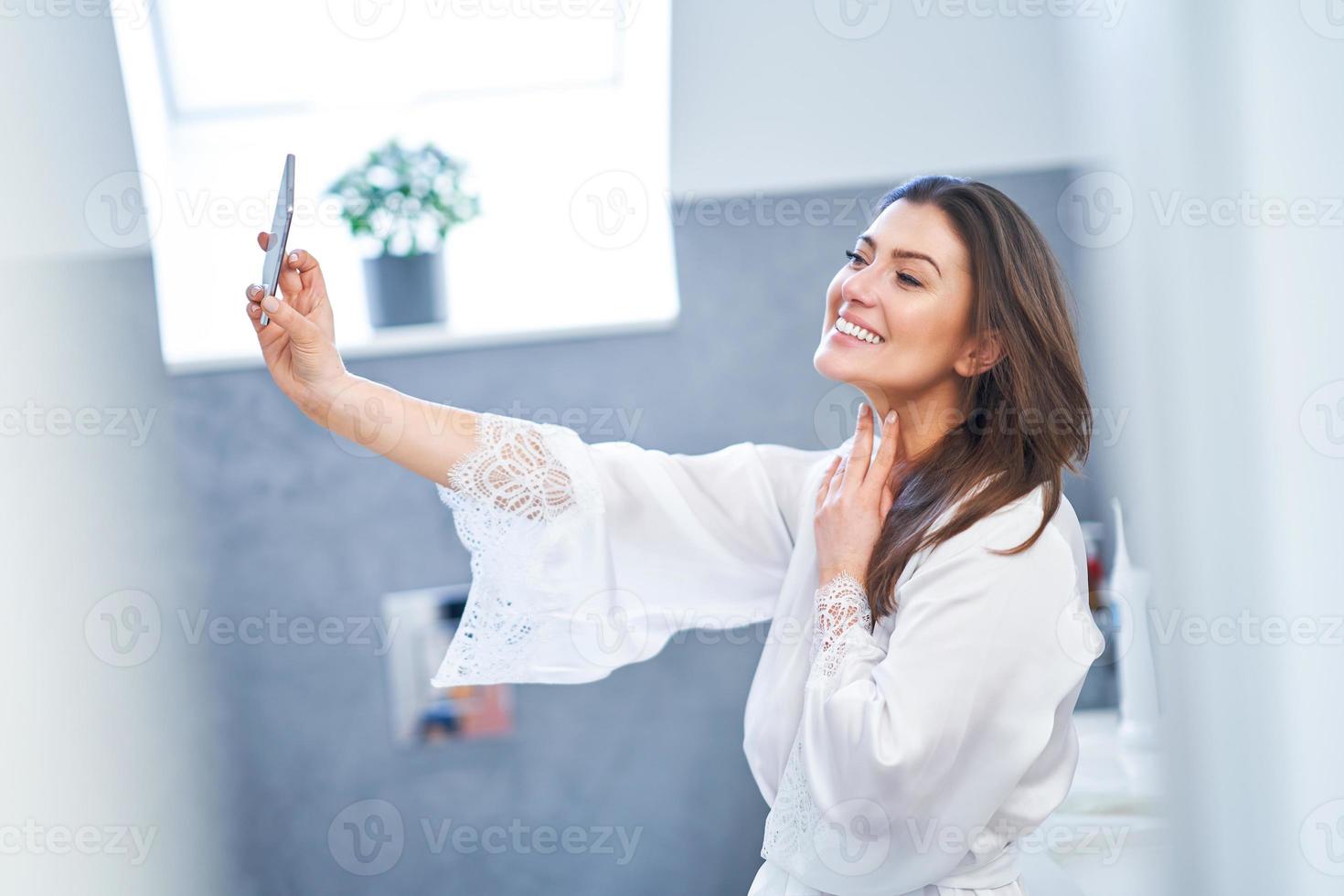 Young nice brunette woman in the bathroom photo