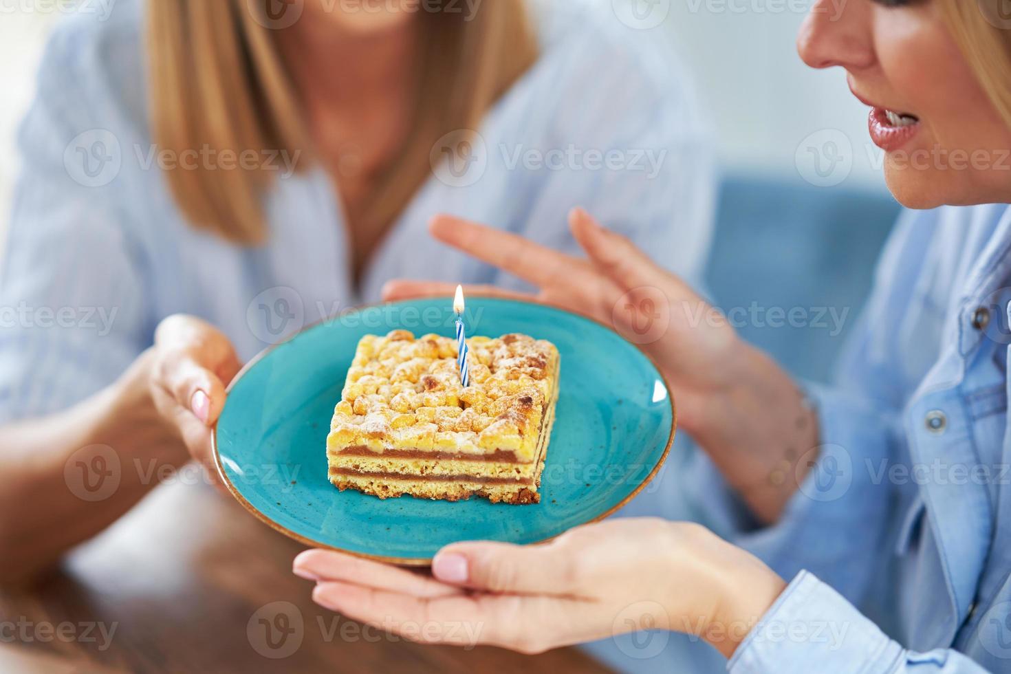 Nice two adult girls in the house with birthday cake photo