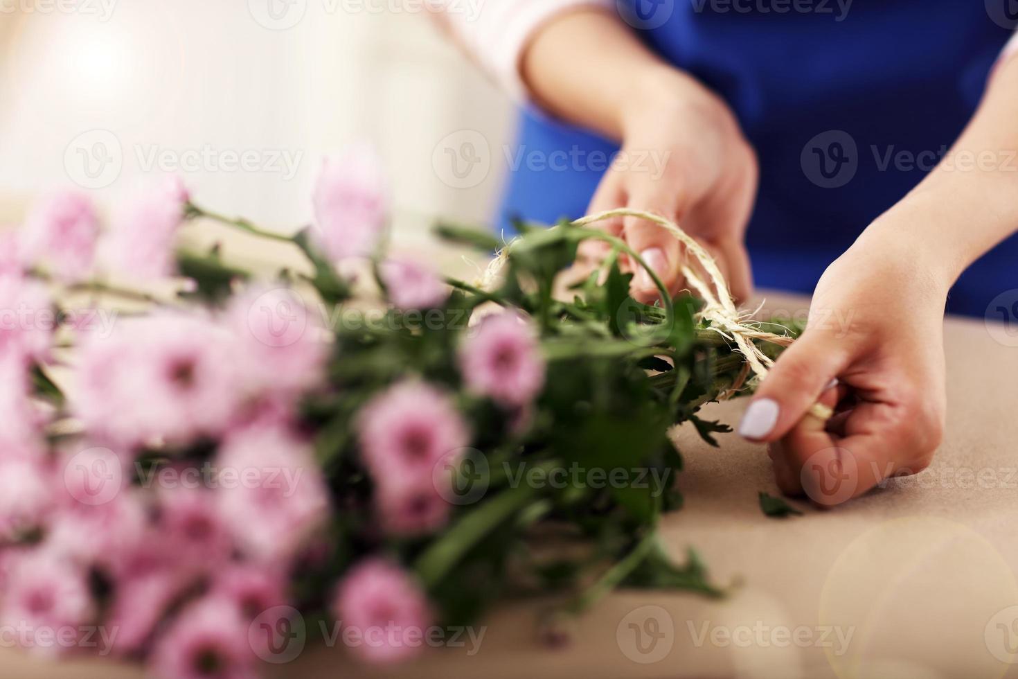 Female florist working in flower shop photo