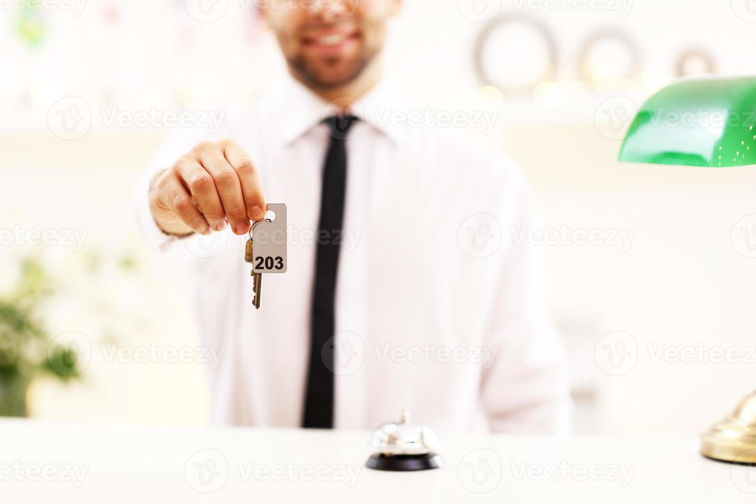 Happy receptionist working in hotel photo