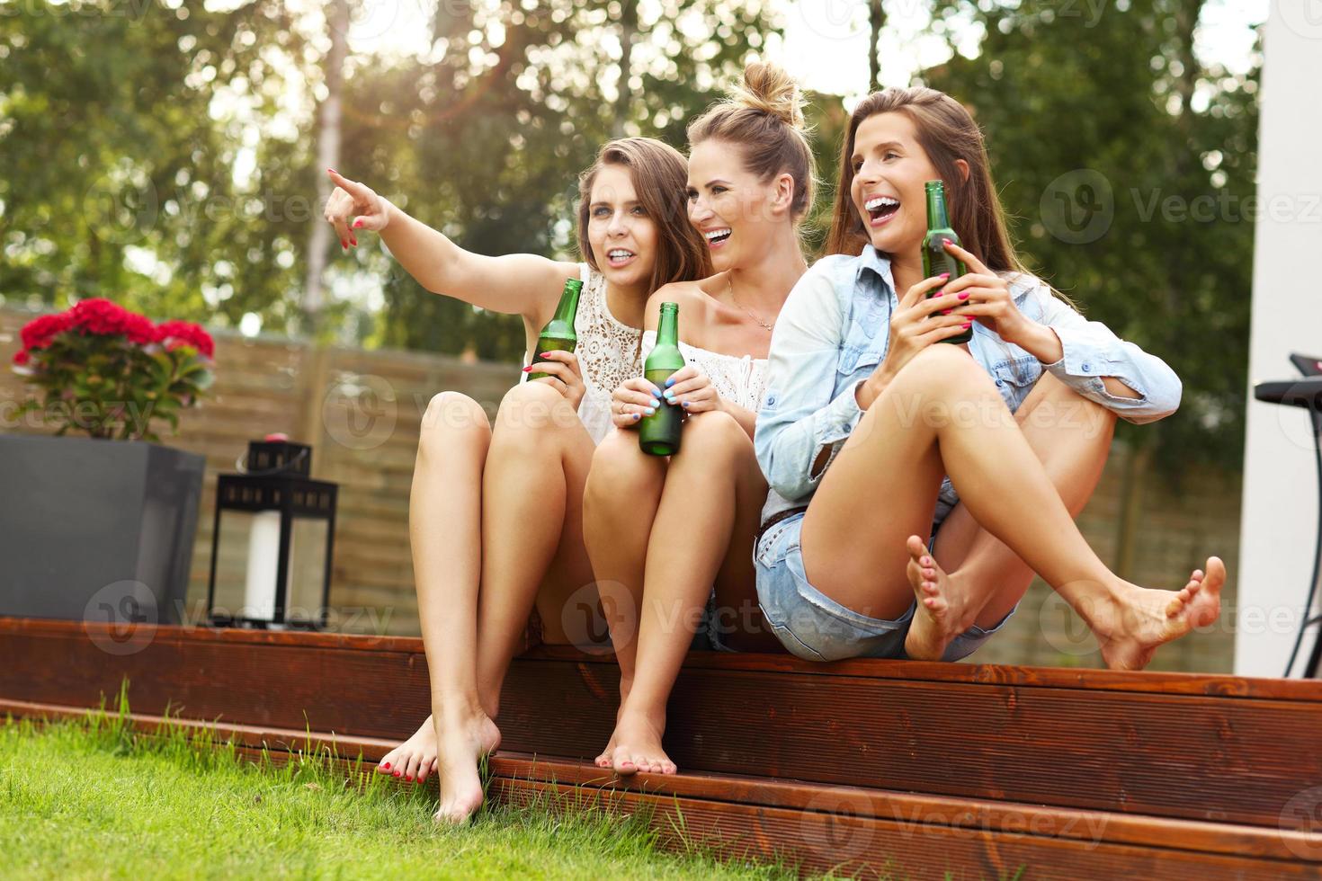 Happy group of friends drinking beer outdoors photo