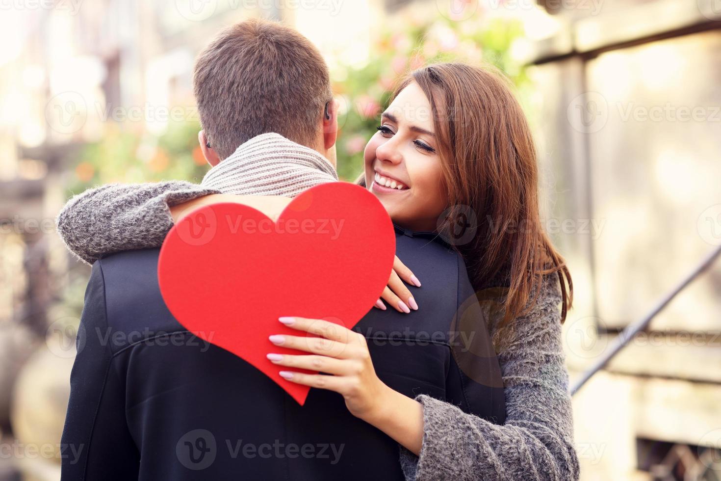 Woman with heart giving hug to her man photo
