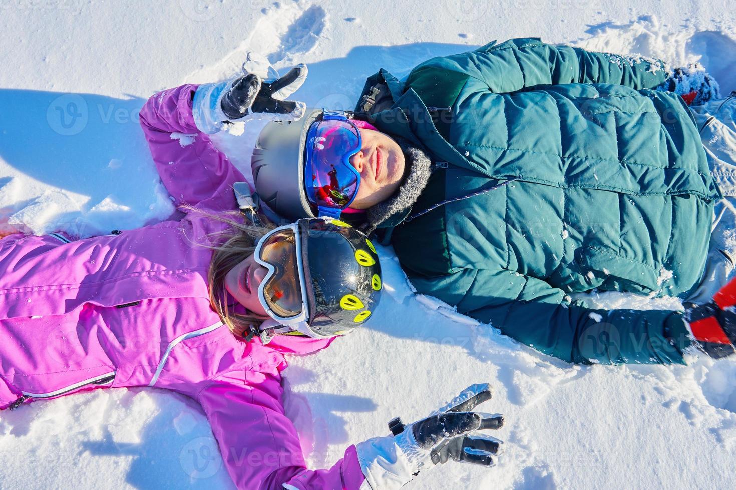 Young couple having fun on the snow photo