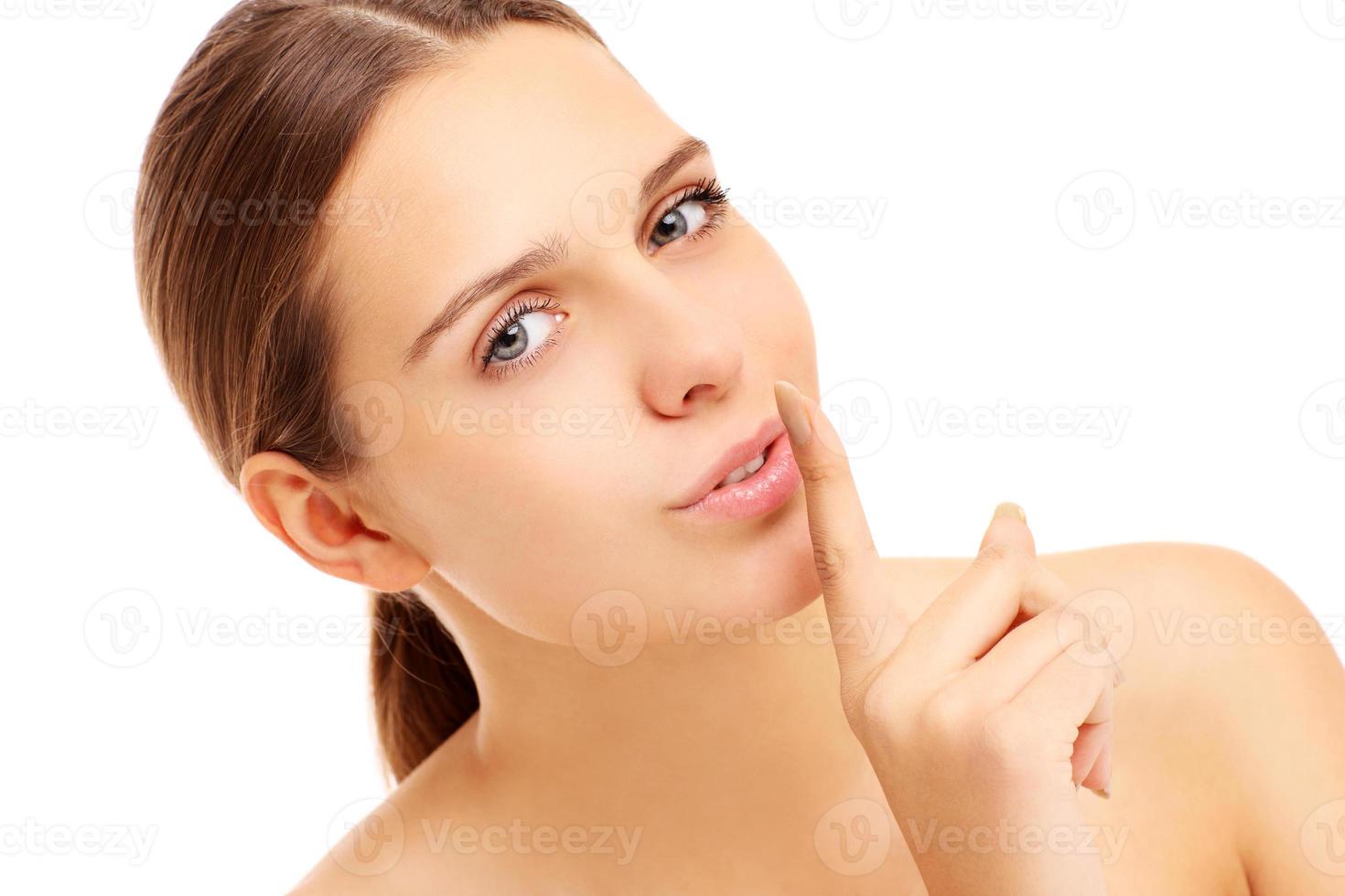 Woman with a finger on her lips photo