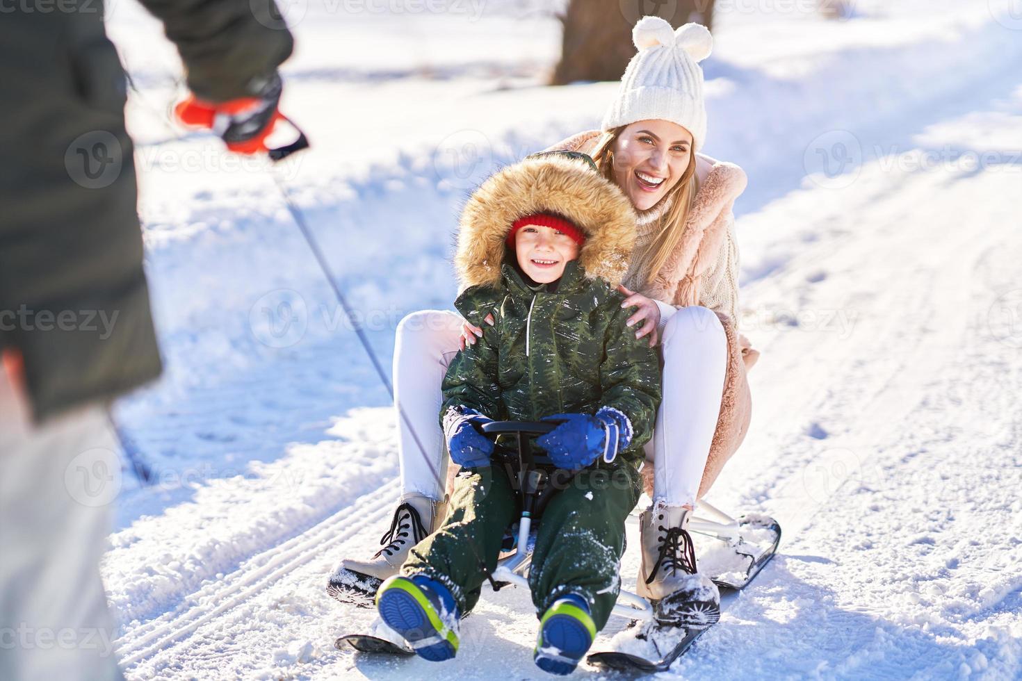 Nice happy family having fun on winter snow photo