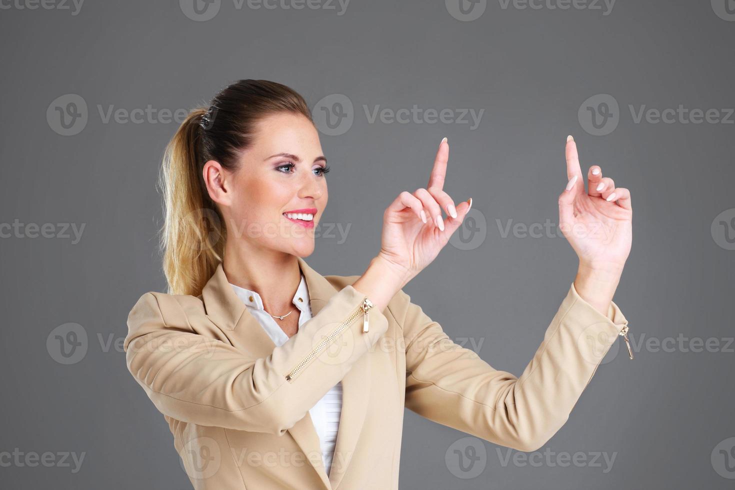 Businesswoman and touchscreen photo