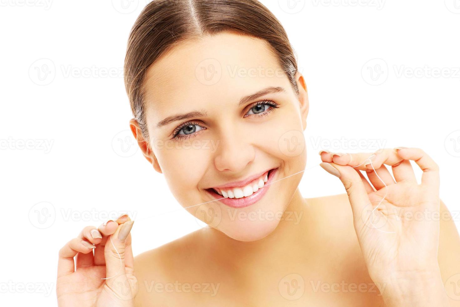 Woman using dental floss photo