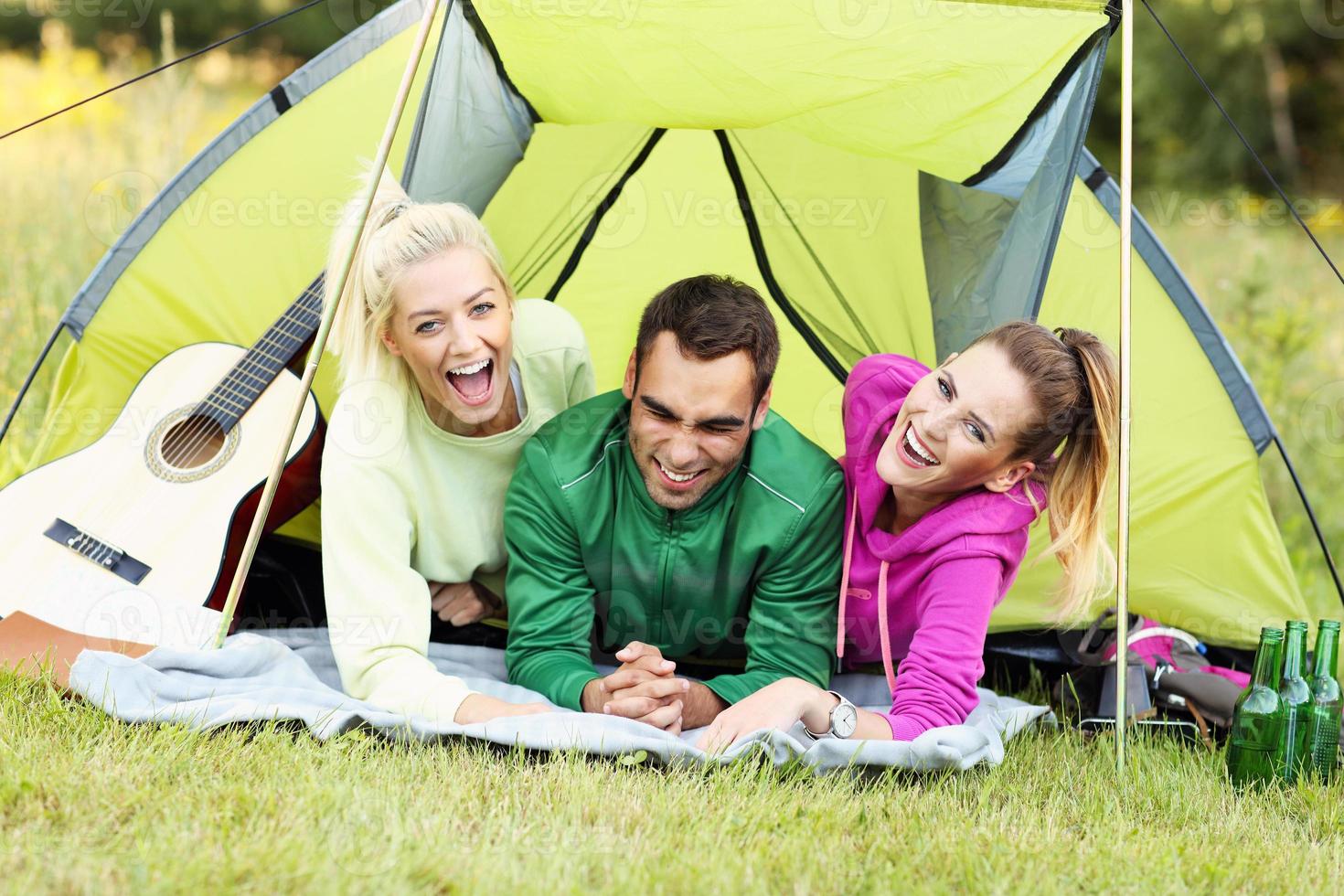 Group of friends camping in forest photo