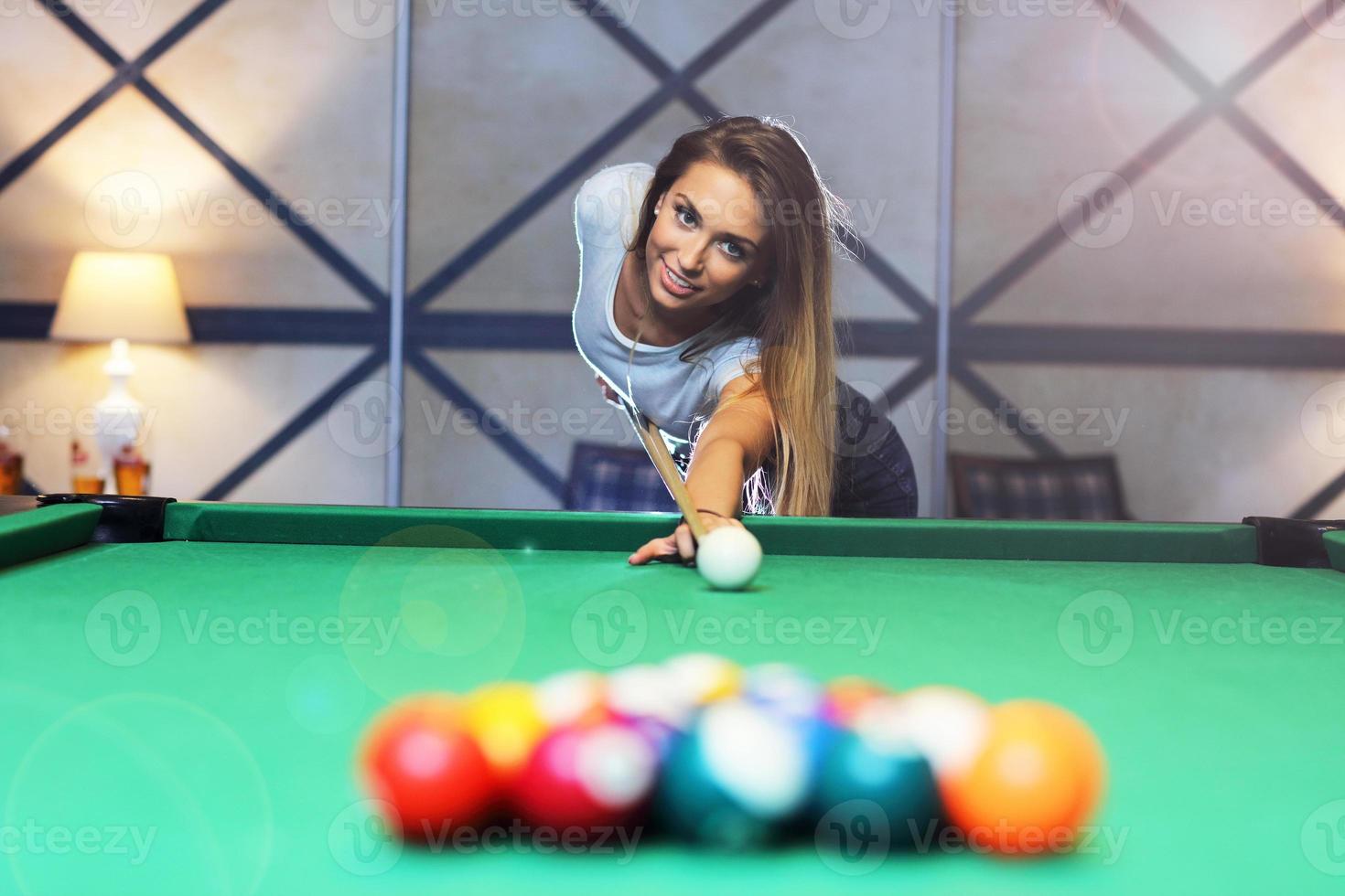 Pretty woman playing billards photo