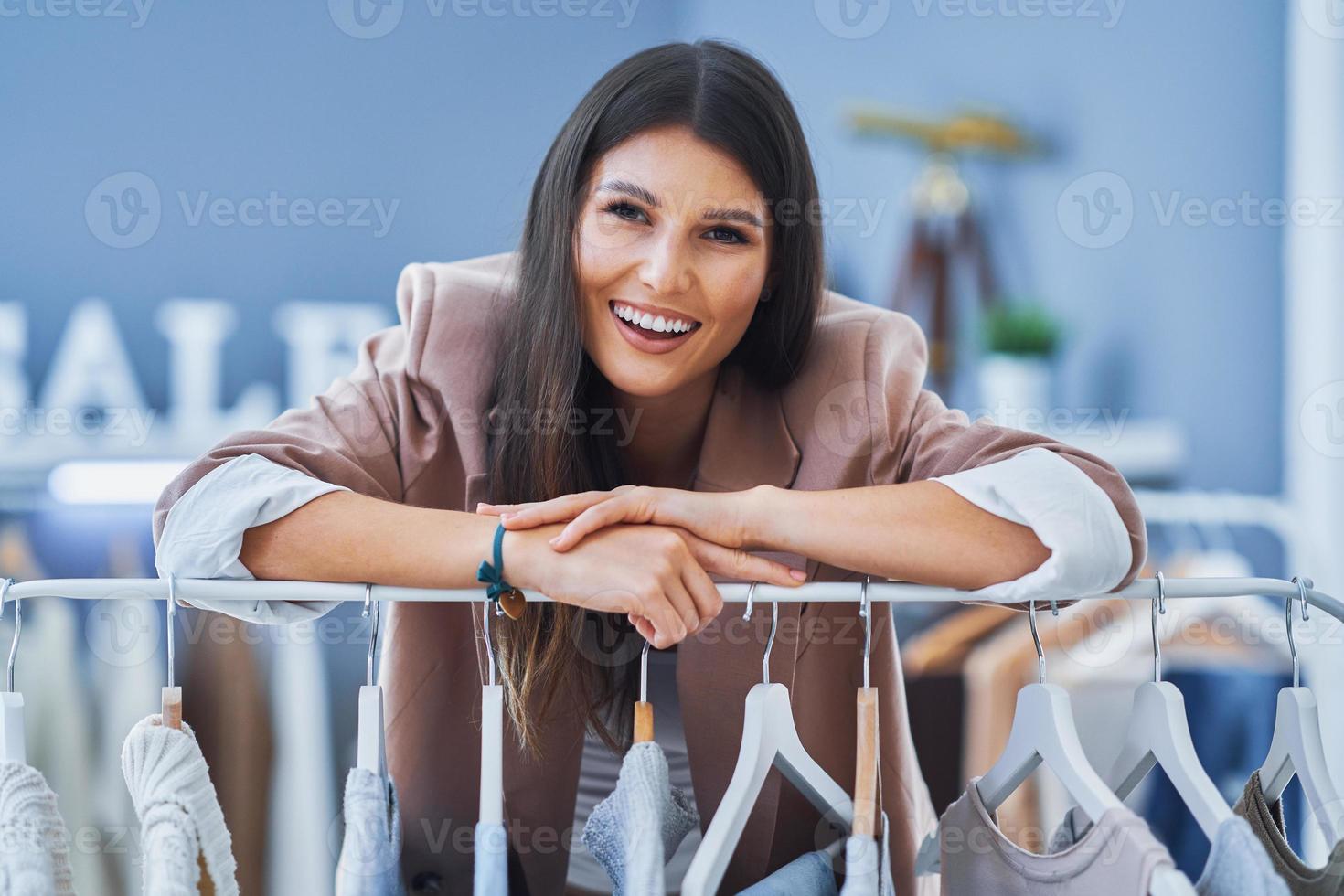 Young woman as a store manager with clothes photo